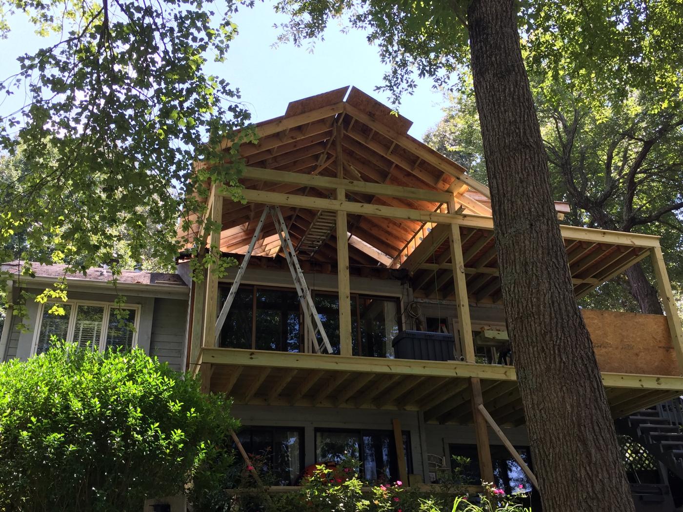 Timber-framed gable going up on a two-story porch